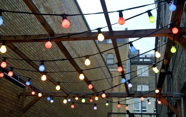 Decorative coloured lighting hanging from a wooden canopy