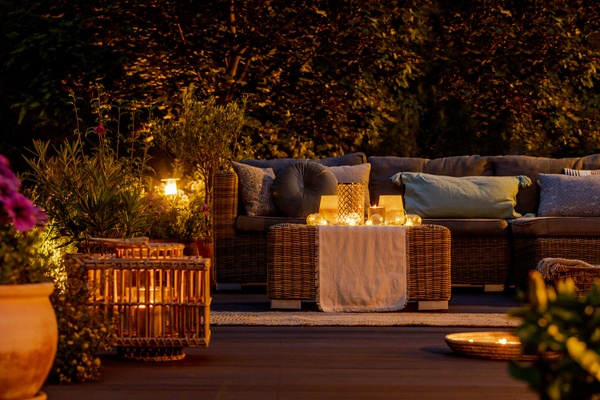Furniture, lights, lanterns and candles in the garden at night