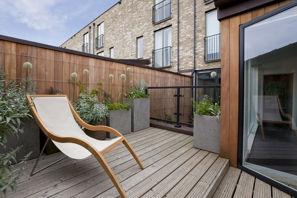 An urban balcony garden with easy chair