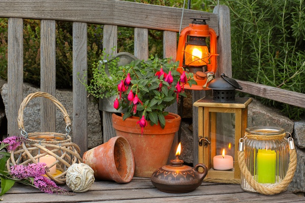 Different lanterns on a wooden bench