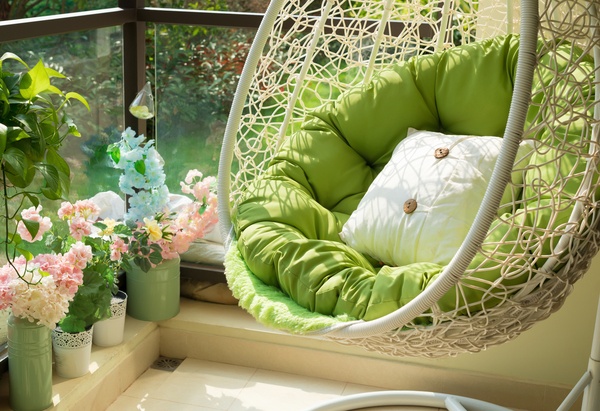 Garden swing with mattress and cushion in a balcony