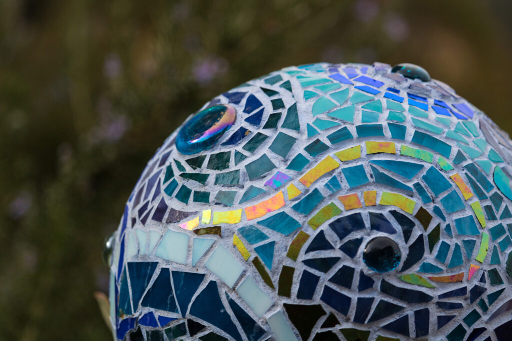 Brightly coloured mosaic garden art globe