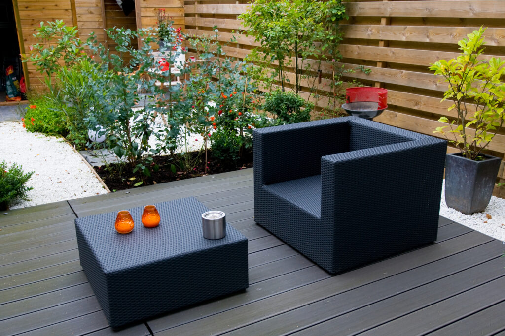 Modern garden with grey furniture flowers and greenery