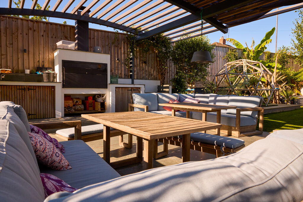 Cosy outdoor seating area under a curved pergola